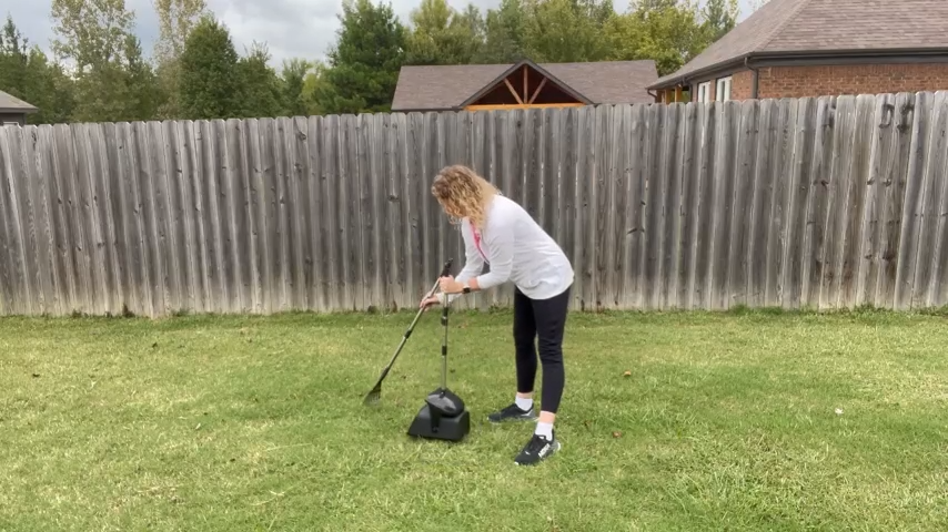 A member of the Tidy Pet Pros team cleaning a yard